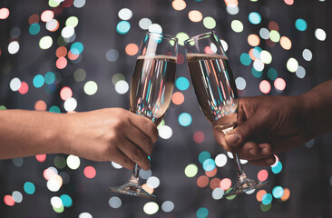 a girl and a guy are mated with glasses of champagne on a beautiful festive bokeh background, consisting of colored out of focus lights on a dark background