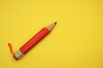 A red pencil isolated on the yellow background 