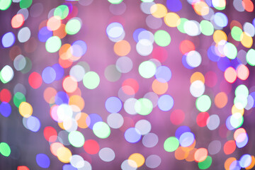 beautiful colored bokeh festive background consisting of multicolored lights out of focus on dark background