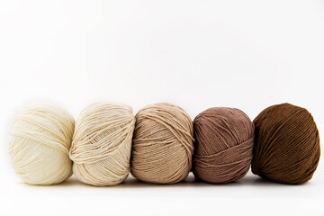 Balls of yarn for knitting brown flowers on a white background.