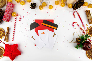 DIY step-by-step instructions for a Christmas card with children. Volumetric snowman on a postcard...