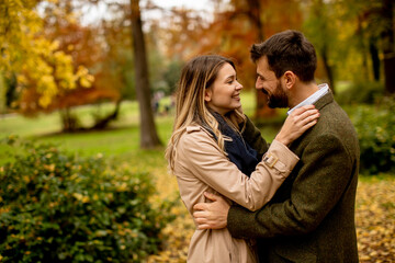 Young couple walking in the autumn park