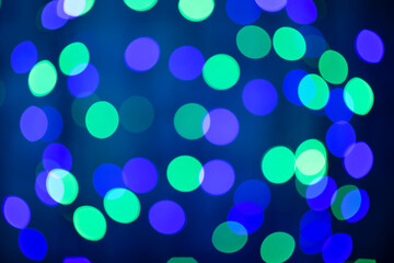 beautiful colored bokeh festive background consisting of multicolored lights out of focus on dark background
