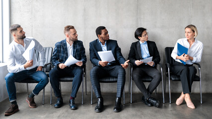 Men Staring At Woman Applicant Waiting For Job Interview Indoors - obrazy, fototapety, plakaty