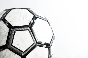 Dirty soccer ball close-up on a white background.