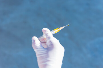 Image of Hand holds Coronavirus Covid-19 Vaccine glass bottle.