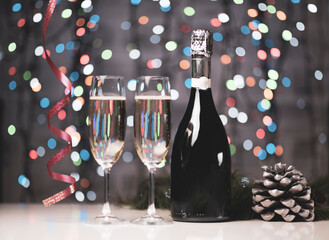 a dark bottle of wine on a beautiful festive bokeh background, composed of colored out of focus lights on a dark background