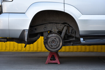 Car without wheels at the maintenance service