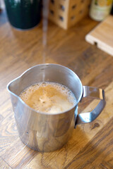Barista prepares coffee in a paper cup