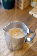 Barista prepares coffee in a paper cup