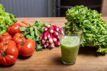 Varied organic vegetable harvest on a wooden kitchen table