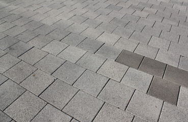 Grey brick stone street road. Light sidewalk, pavement texture