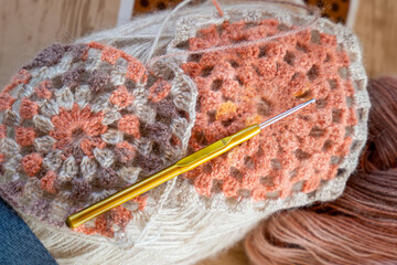 Close-up, grey and multi colored yarns and crochet needle. 
