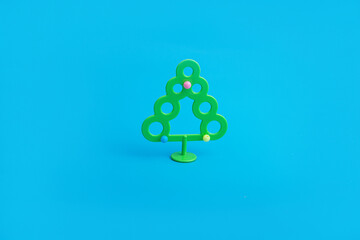 Creative layout with a Christmas tree on a bright blue background. Minimal winter nature holiday scene.