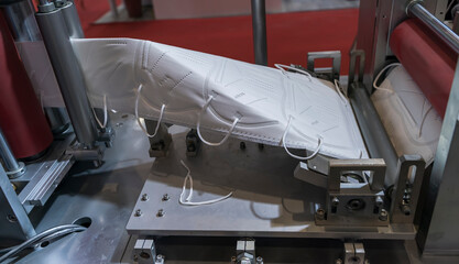 medical masks on automatic machine for the manufacture. Coronavirus and Covid-19 Protection