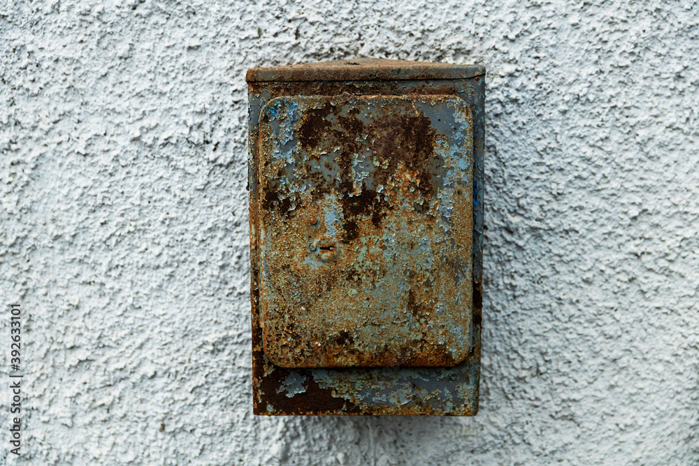 Poster old rusty mailbox hanging on stone texture wall