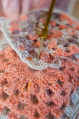 Close-up, grey and multi colored yarns and crochet needle. 