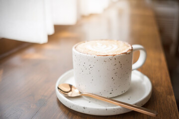 Coffee in a white cup and light from the window