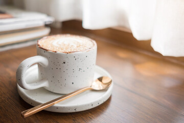 Coffee in a white cup and light from the window