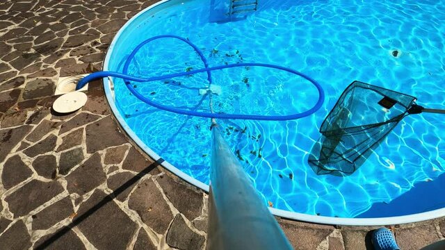 POV of vacuum cleaner cleaning bottom of swimming pool.