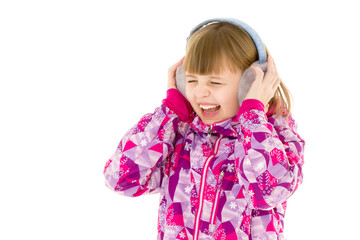 A little girl with headphones listening to music.