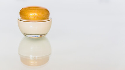 Jar and pills with hemp lotion on white background, skin care cannabis three leafs