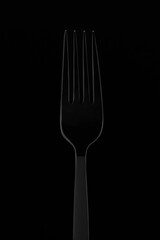 silhouette of a dining fork on a dark background