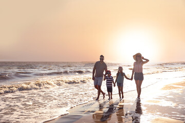 Happy family on sandy beach near sea