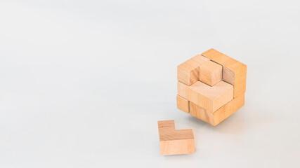 Wooden square block cube puzzle. Isolated on white background. Concept of complex and smart logical thinking. Slightly defocused and close up shot