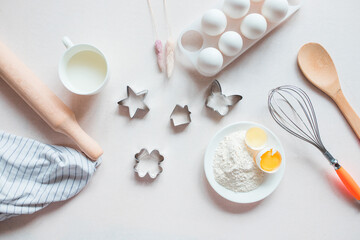 Fototapeta na wymiar Cook cookies. Tools and ingredients for making sweet pastries or cupcakes. Cooking, flour, eggs, bakeware on a white background. Cooking Ingredients. Cooking gingerbread. Culinary textiles, baked 
