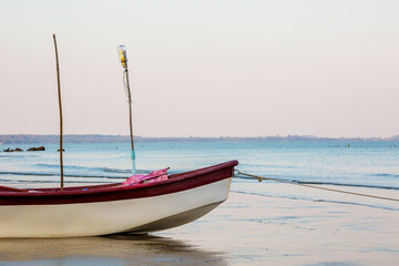 Naklejka na ściany i meble Small fishing boat at beach
