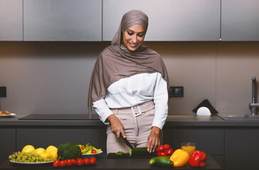 Muslim Wife Cooking Dinner In Modern Kitchen At Home