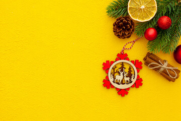 Spruce branch, cones and vintage toys decoration on christmas or new year on yellow background