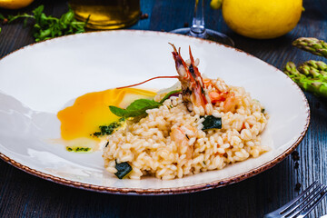 Risotto with seafood on white plate.