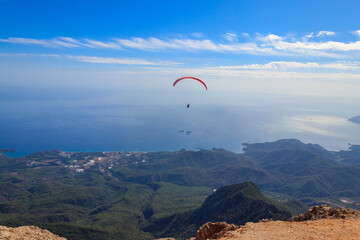 Fototapeta na wymiar Paragliders flying from a top of Tahtali mountain near Kemer, Antalya Province in Turkey. Concept of active lifestyle and extreme sport adventure