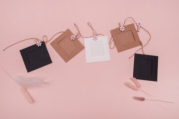 Decorative frame. Album design concept for photo. Scrapbooking. Texture on a pink background photo frames on a rope, photo camera. photo frames for photos. attach picture to the rope with a clothespin