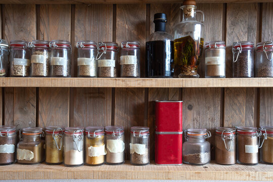 Bottles With Spices And Seasonings In Wooden Rack. Various Different Organic Herbs For In The Kitchen Vintage Look