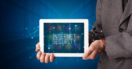 Young business person working on tablet and shows the digital sign: INTERNET SECURITY