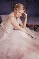 Fototapeta na wymiar Beautiful bride with nature make-up in pink dress 
