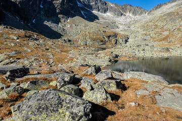  Pond in Valley of Five Spis Lakes surrounded by rocky summits, High Tatra Mountains, Slovakia.