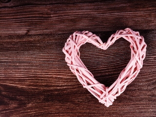 Wicker heart decoration on grunge wooden background valentine's day concept
