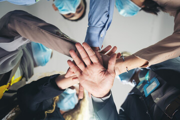 Bottom view of businesspeople join hands. Group of diverse corporate colleagues putting their hands together in the office modern. teamwork and successful concept