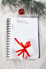 Fototapeta na wymiar Top view of blank notebook for goals resolutions and christmas decoration