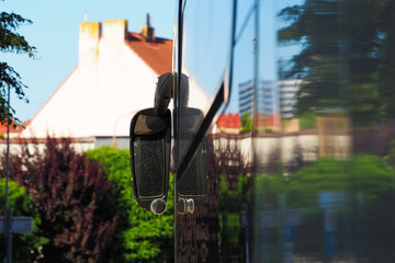 Reflection of the old city on the glass of the bus. Tourist bus parked in the city, back view