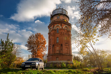 Obraz premium Old water tower in the autumn city. Autumn architecture..