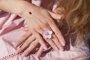 Insect ladybug on the arm of a young woman
