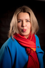 Cheerful 40 years old woman in blue coat and red kerchief emotional portrait