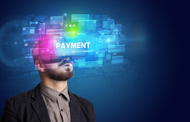 Businessman looking through Virtual Reality glasses with PAYMENT inscription, innovative security concept