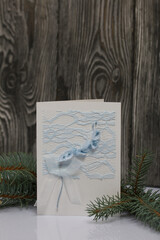 Greeting card among the fir branches. On black pine boards.