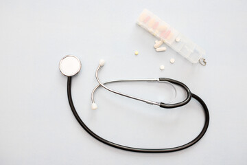 Stethoscope, pills, heart. Isolated over white background. The concept of medicine.